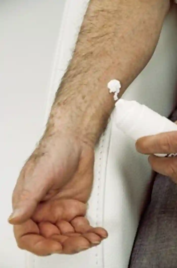 Man applying a skin cream containing <a  tabindex='0' class='popover-dismiss' href='/hormones/testosterone/' data-target-type='infoSheet' data-target-url='/hormones/testosterone/' data-bs-toggle='popover' data-bs-trigger='focus' title='testosterone' data-bs-content='1429' >testosterone</a> used to replace this sex hormone in men who have lost their sex drive, or had their <a  tabindex='0' class='popover-dismiss' href='/glands/testes/' data-target-type='infoSheet' data-target-url='/glands/testes/' data-bs-toggle='popover' data-bs-trigger='focus' title='testes' data-bs-content='1454' >testes</a> removed due to cancer or other diseases.